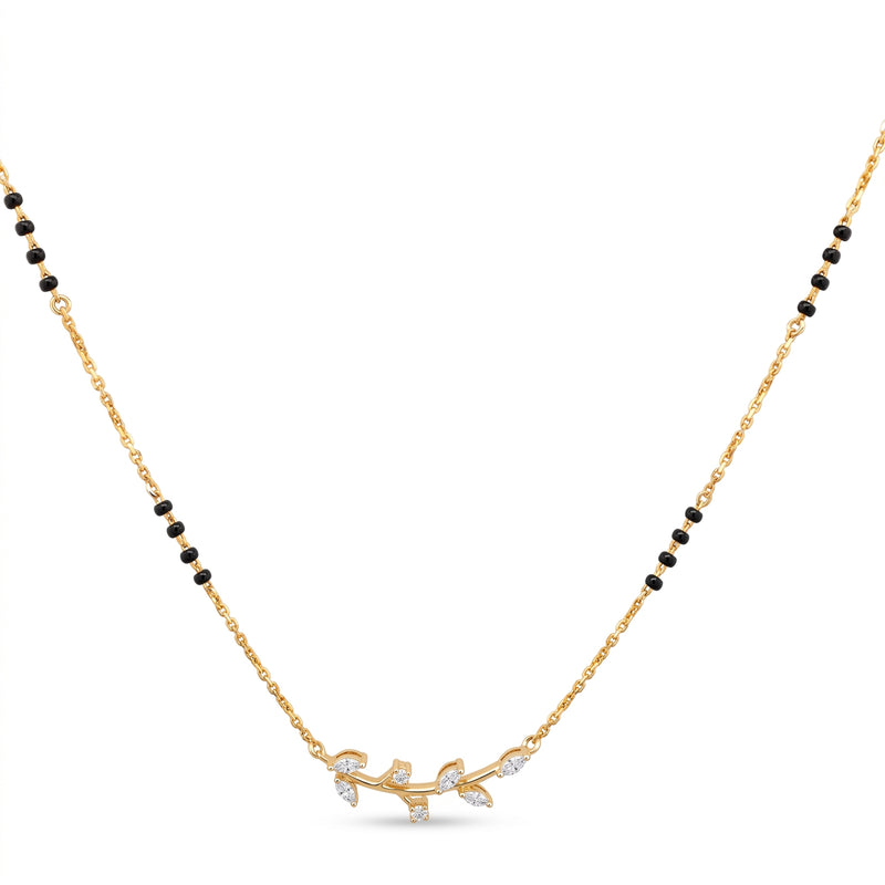 A gold chain necklace featuring a delicate branch-shaped pendant adorned with small clear stones, flanked by rows of small black beads on each side, shown against a plain white background.