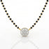 A gold and black beaded necklace with a round pendant featuring a halo of small clear stones, shown on a white background with a soft reflection.