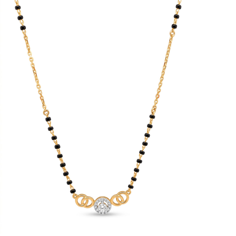 A gold and black beaded necklace with a central gold pendant featuring a clear round-cut diamond, displayed on a clean white background.