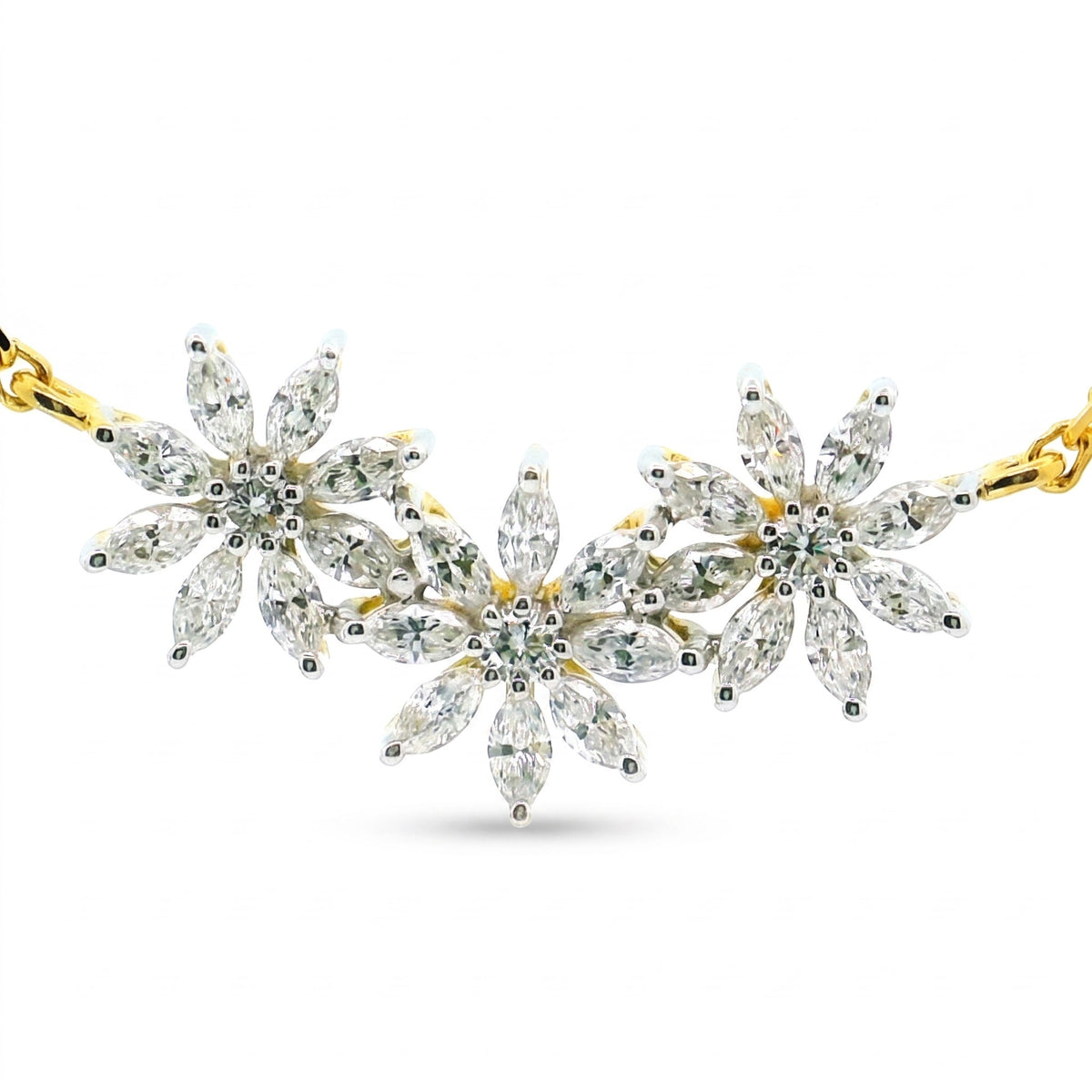 A gold and silver floral necklace featuring marquise-cut clear gemstones in a daisy chain pattern, displayed on a clean white background.