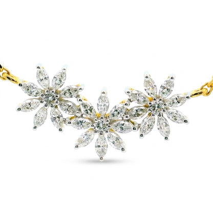 A gold and silver floral necklace featuring marquise-cut clear gemstones in a daisy chain pattern, displayed on a clean white background.
