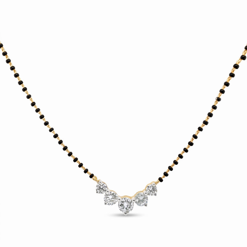 A yellow gold and black bead chain necklace with a V-shaped pendant featuring clear gemstones, shown on a plain white background.