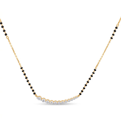 A delicate gold chain necklace featuring a curved central section set with small clear stones, flanked by rows of tiny black beads, on a plain white background.