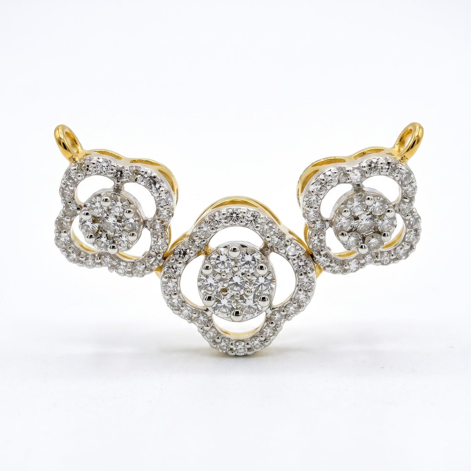 A yellow gold and diamond jewelry piece featuring three interlocking floral or clover-like motifs, photographed on a clean white background.