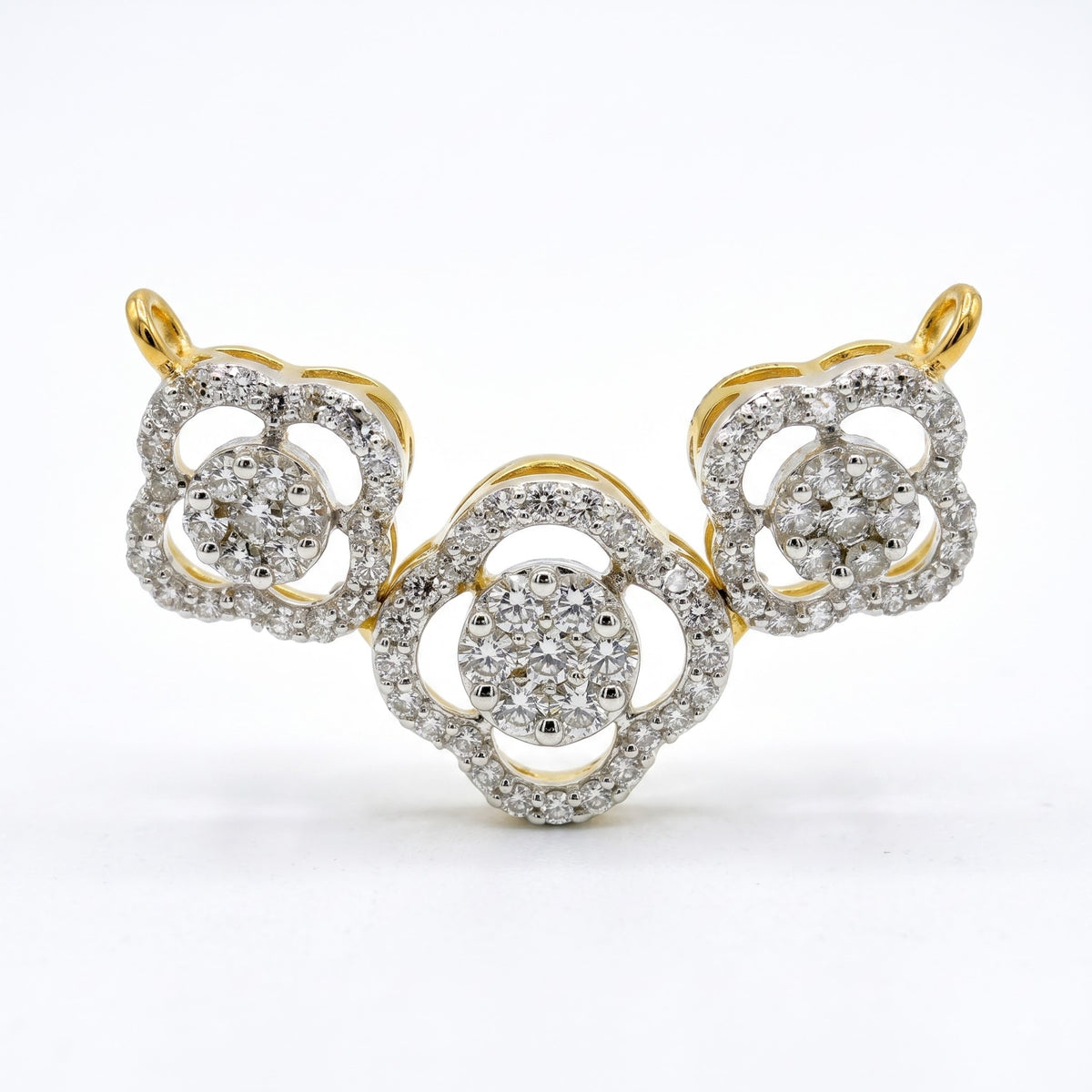 A yellow gold and diamond jewelry piece featuring three interlocking floral or clover-like motifs, photographed on a clean white background.