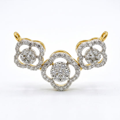 A yellow gold and diamond jewelry piece featuring three interlocking floral or clover-like motifs, photographed on a clean white background.