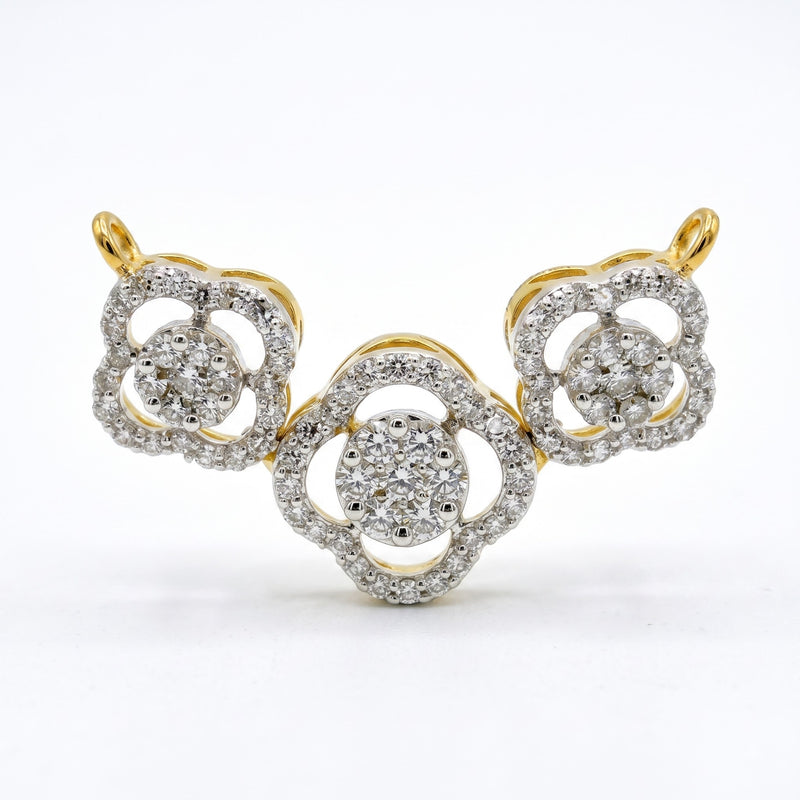 A yellow gold and diamond jewelry piece featuring three interlocking floral or clover-like motifs, photographed on a clean white background.