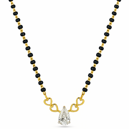 A gold and black beaded necklace featuring a pear-cut clear gemstone pendant held by three gold heart-shaped links, shown on a plain white background.