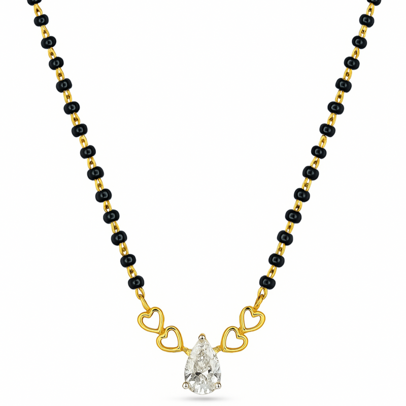 A gold and black beaded necklace featuring a pear-cut clear gemstone pendant held by three gold heart-shaped links, shown on a plain white background.