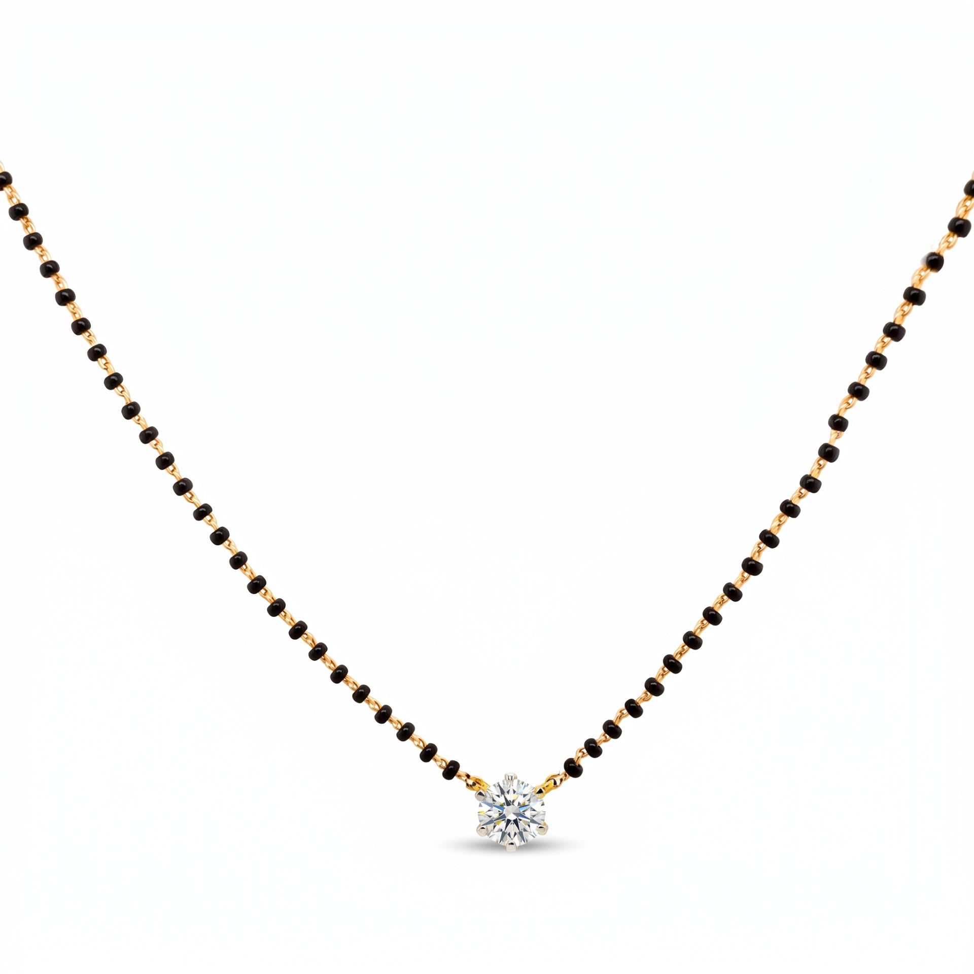 A delicate black and gold beaded necklace with a small, clear, multi-stone starburst pendant, displayed on a solid white background.