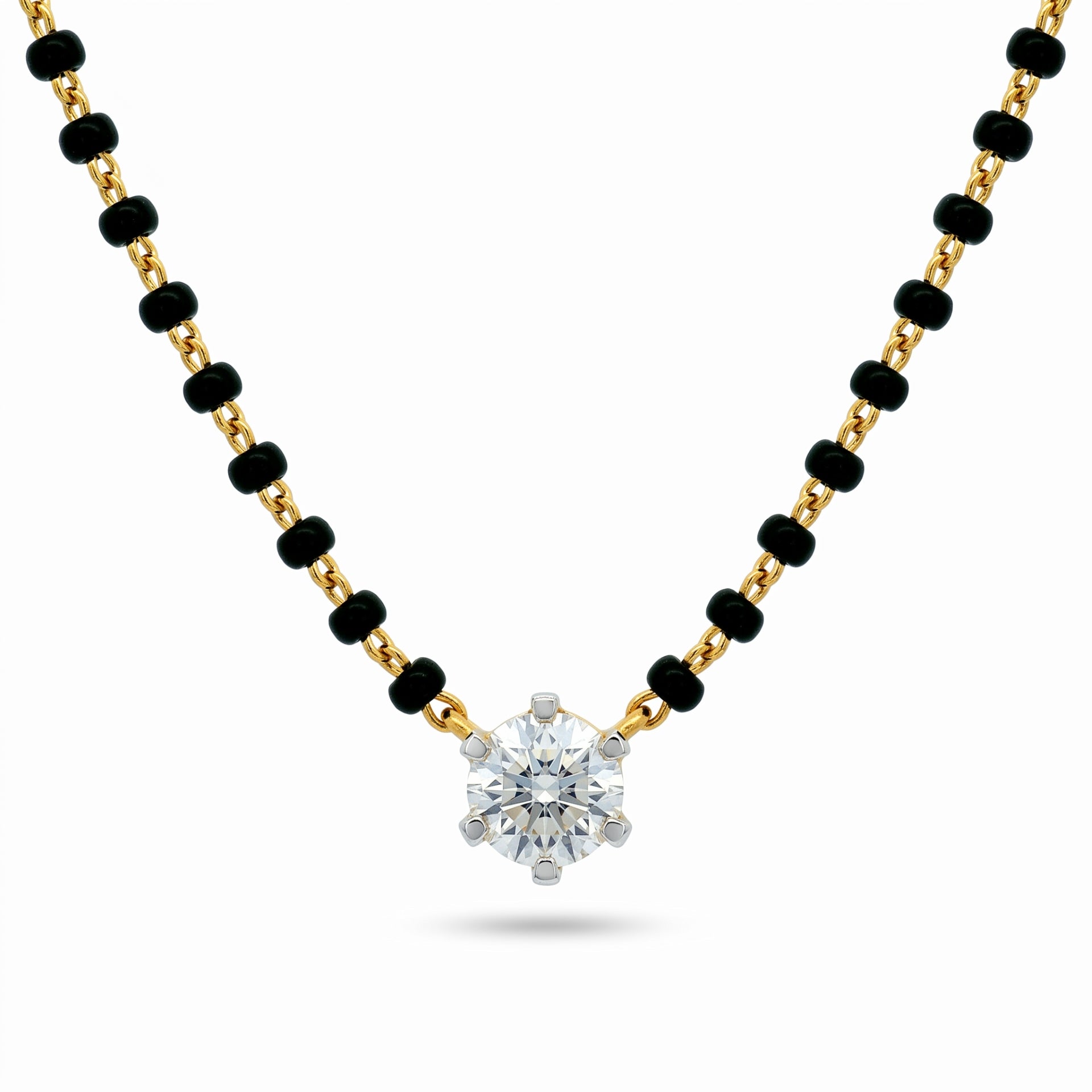 A gold and black beaded necklace with a single round-cut clear gemstone pendant, displayed on a clean white background.