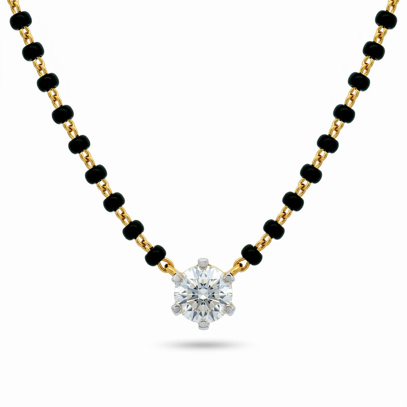 A gold and black beaded necklace with a single round-cut clear gemstone pendant, displayed on a clean white background.