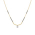 A delicate gold chain necklace featuring a black bead line on either side of a curved gold pendant, with a small clear gemstone at the center holding a star-shaped setting, shown against a plain white background.