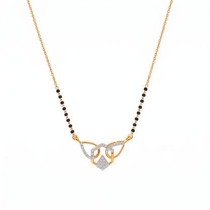 A gold and white gold necklace featuring a beaded chain with a central pendant of interlocking loops, one paved with small clear stones and another with a small diamond pendant, on a white background.