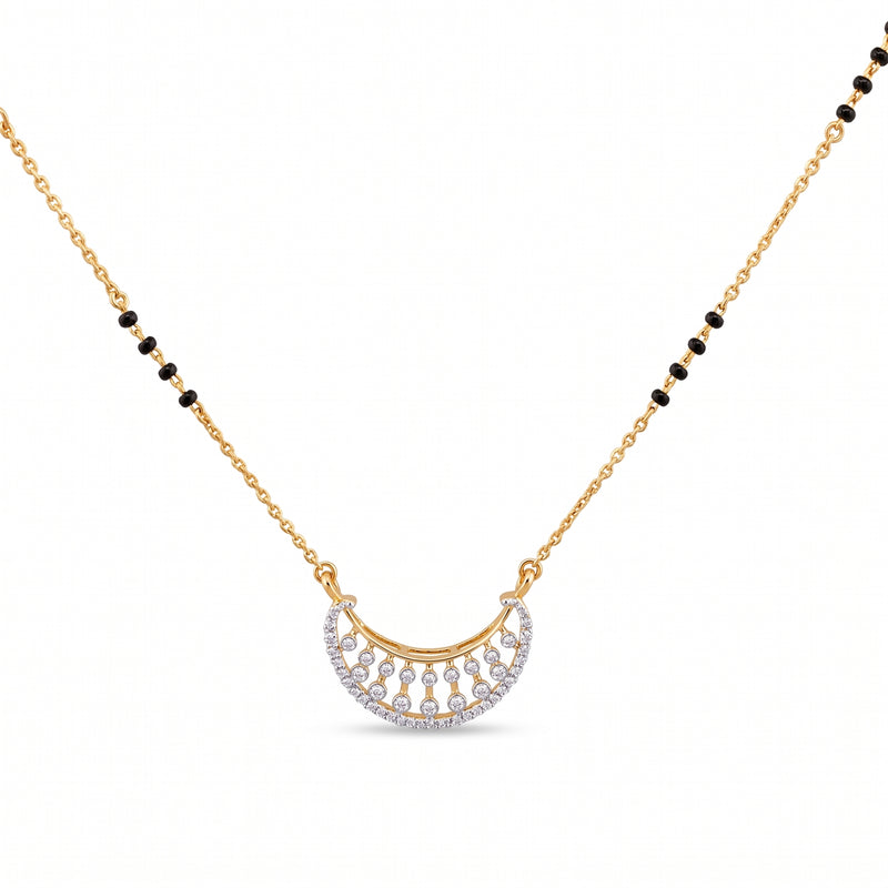 A gold chain necklace featuring a crescent-shaped pendant adorned with small clear stones and black bead accents along the chain, shown on a plain white background.