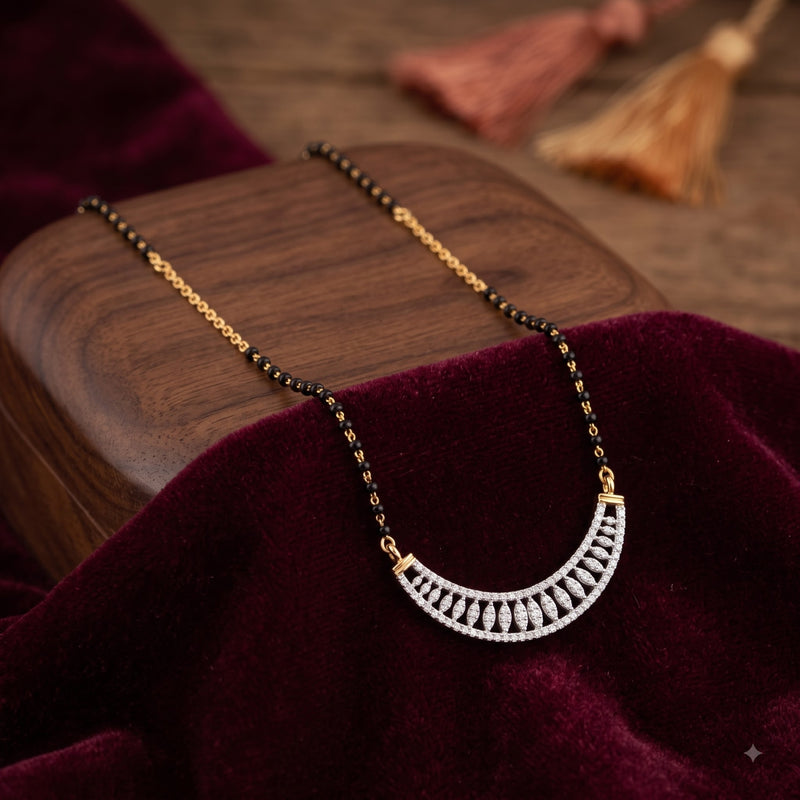 A gold and black beaded necklace with a silver crescent-shaped pendant set with clear stones, displayed on a dark wooden block draped with deep burgundy velvet.