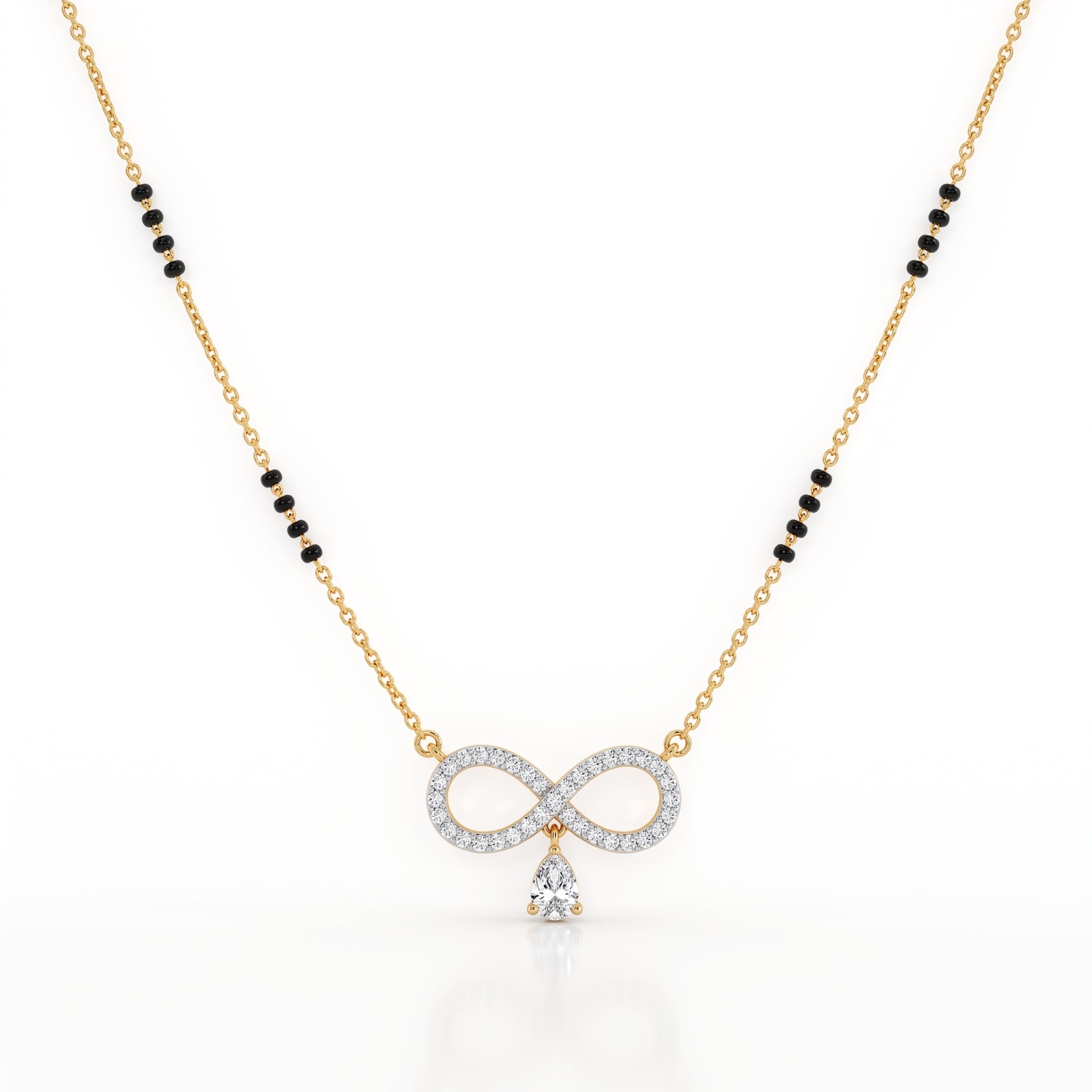 A gold chain necklace featuring a central infinity symbol pendant paved with clear stones and a dangling clear teardrop stone, with small black bead accents along the chain, shown on a white background.