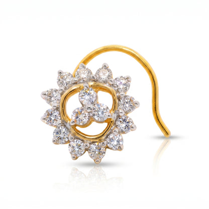 A gold hoop nose ring with a circular sunburst design set with clear round-cut gemstones, shown on a white background with a soft reflection.