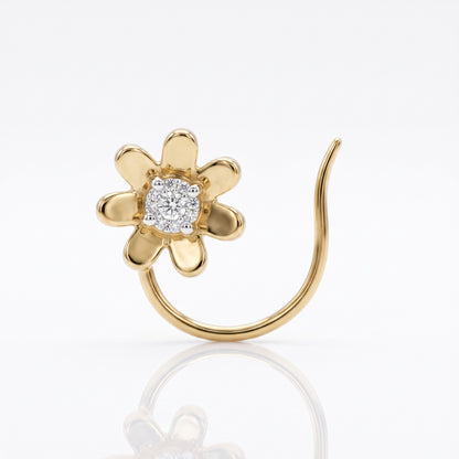 A gold flower-shaped nose stud with a central cluster of clear gemstones, set on a curved gold post, shown on a white reflective background.