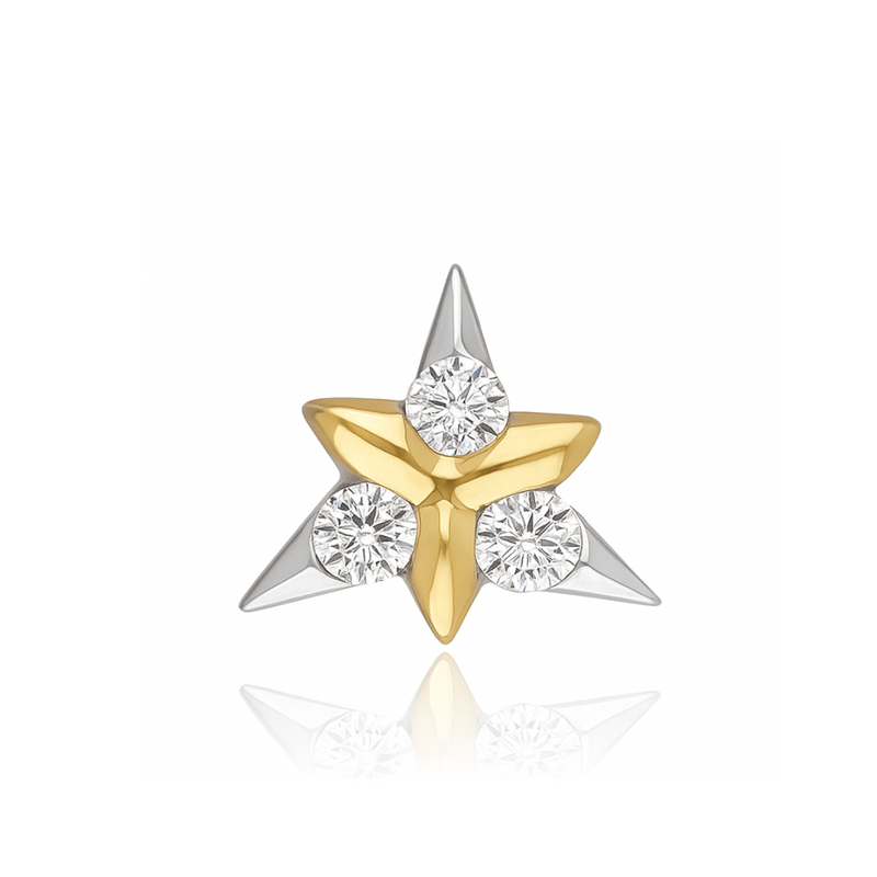 A two-tone star-shaped stud earring featuring a gold center and silver points, accented with three round clear gemstones, shown on a white background with a soft reflection.