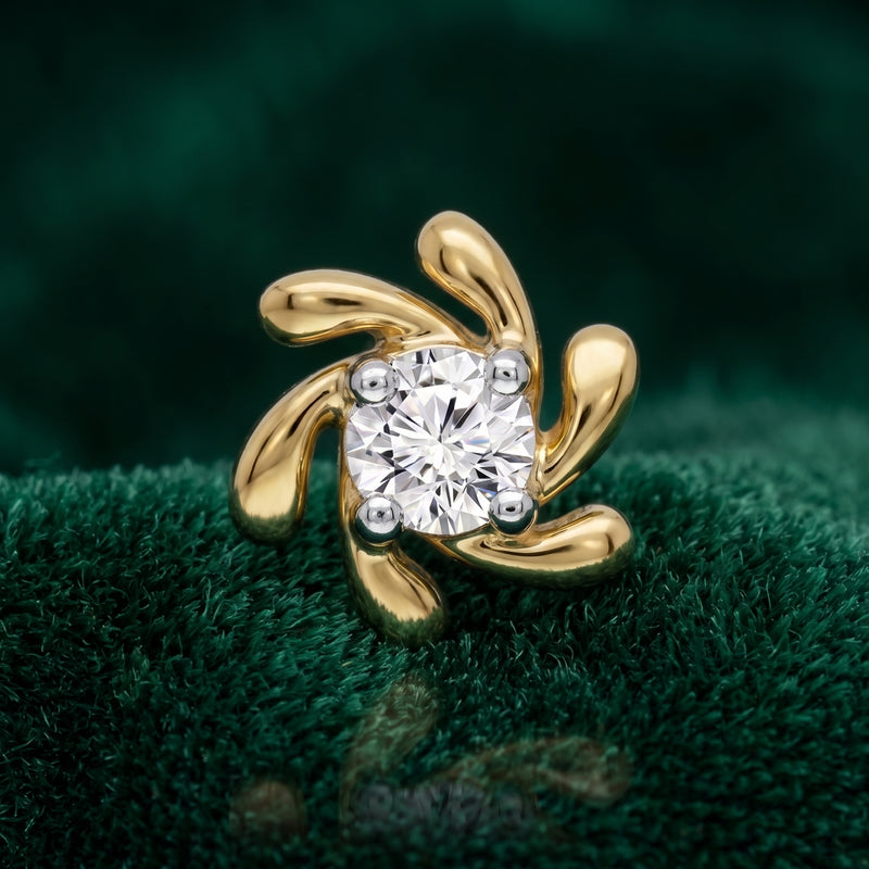 A gold ring featuring a central round clear gemstone surrounded by four curved, leaf-like gold prongs, displayed on a textured dark green velvet surface.