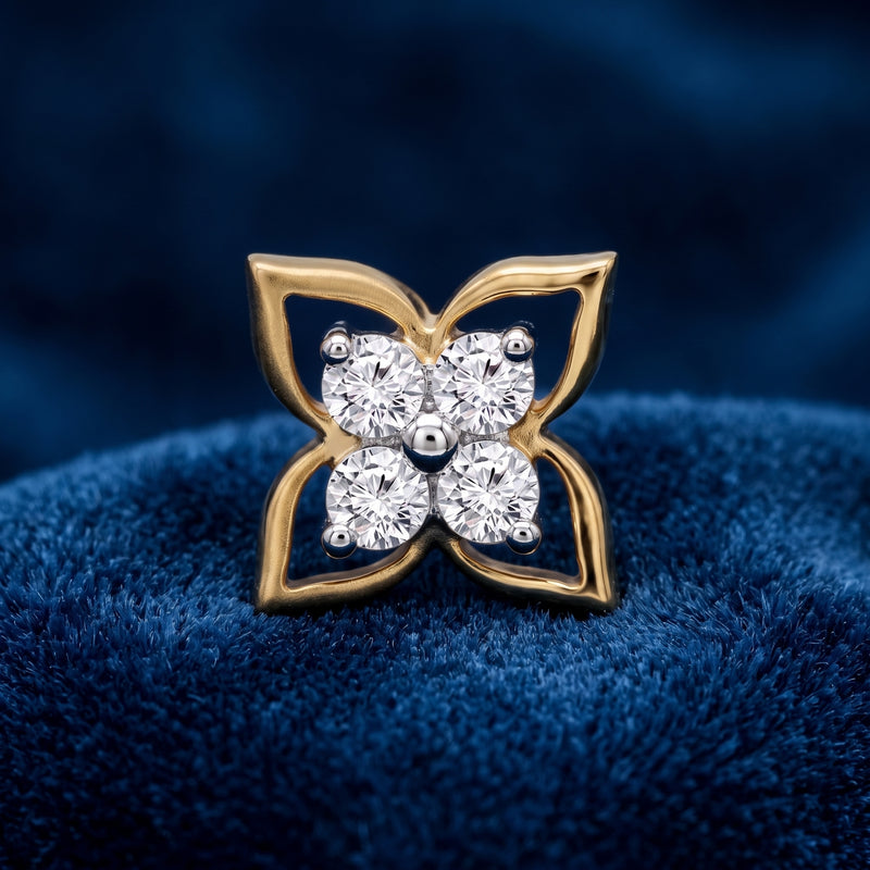 A yellow gold butterfly-shaped nose ring with four clear round-cut gemstones, displayed on a textured dark blue velvet surface.