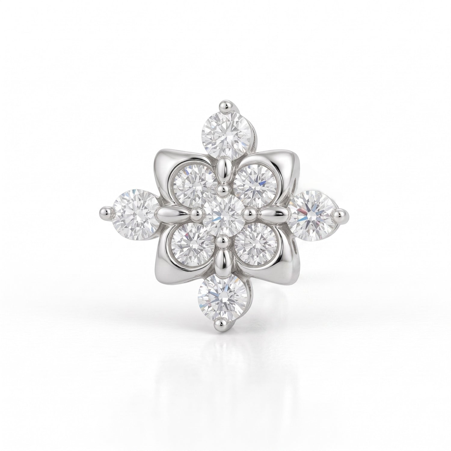 A silver-tone flower-shaped ring featuring multiple round and marquise-cut clear gemstones, set against a clean white background with a soft reflection.
