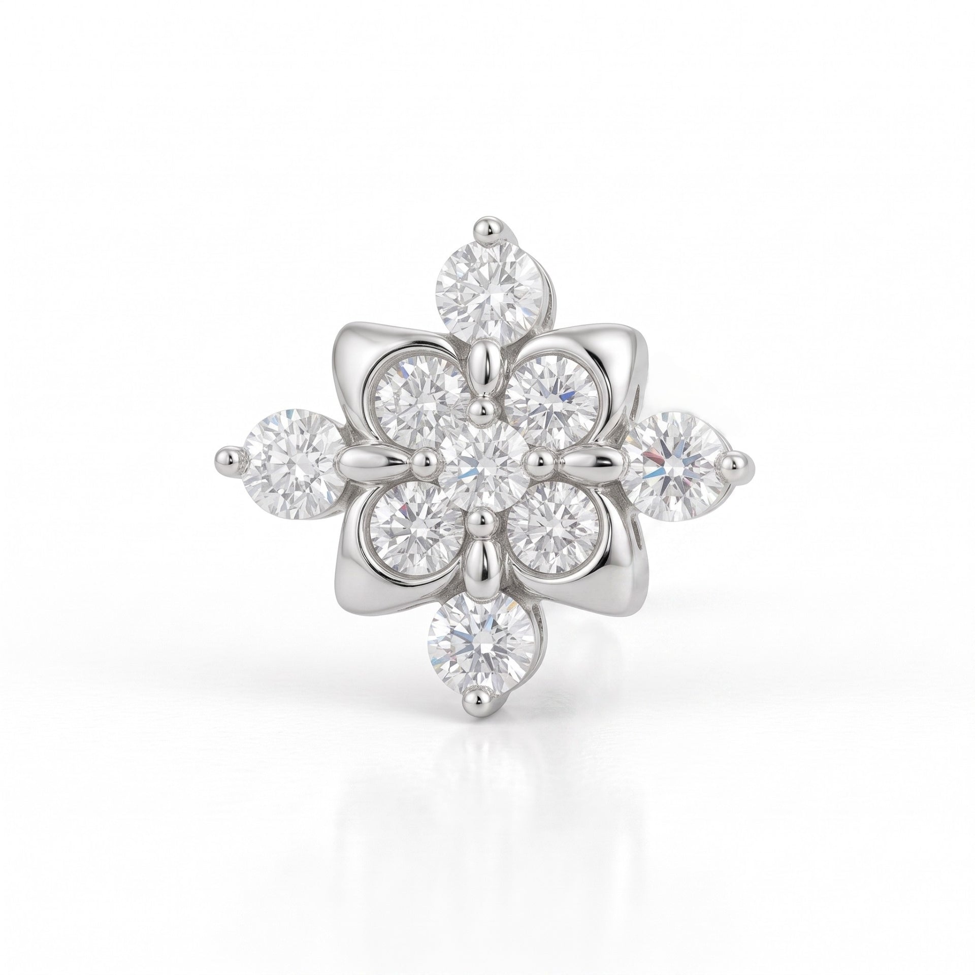 A silver-tone flower-shaped ring featuring multiple round and marquise-cut clear gemstones, set against a clean white background with a soft reflection.