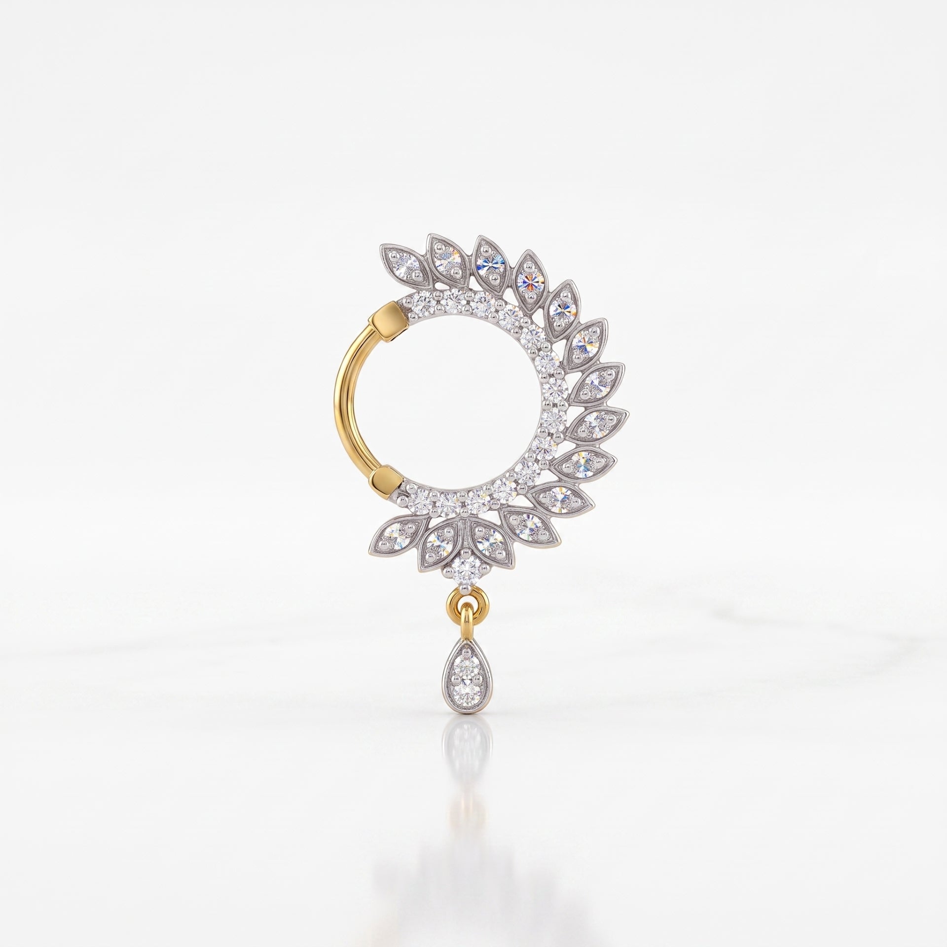 A single gold and silver hoop nosepin adorned with clear pavé gemstones, featuring a circular halo with leaf-like teardrop details and a dangling teardrop charm, set against a clean white background.
