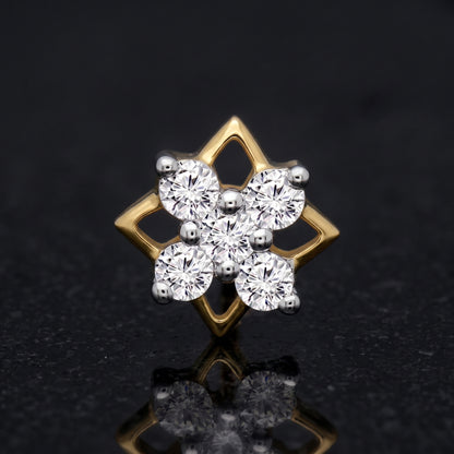 A gold and silver-tone diamond cluster stud nosepin featuring a six-petal floral design with round-cut clear stones, set against a dark reflective background.