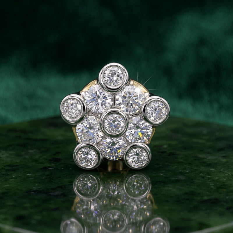 A floral cluster nosepin featuring multiple round brilliant-cut diamonds in a silver-toned setting, displayed on a dark green reflective surface with a matching green background.