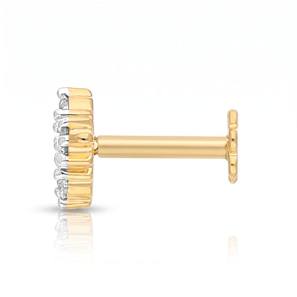 A single gold post stud earring with a textured gold crown-like setting and small clear stones on the front, shown on a white background with a soft reflection.