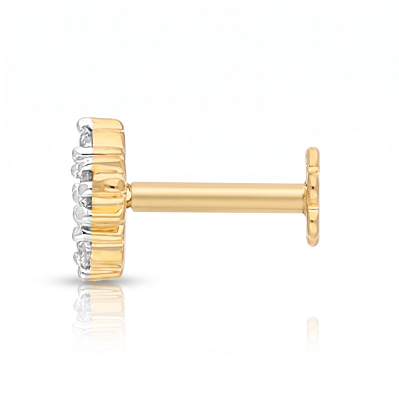 A single gold post stud earring with a textured gold crown-like setting and small clear stones on the front, shown on a white background with a soft reflection.