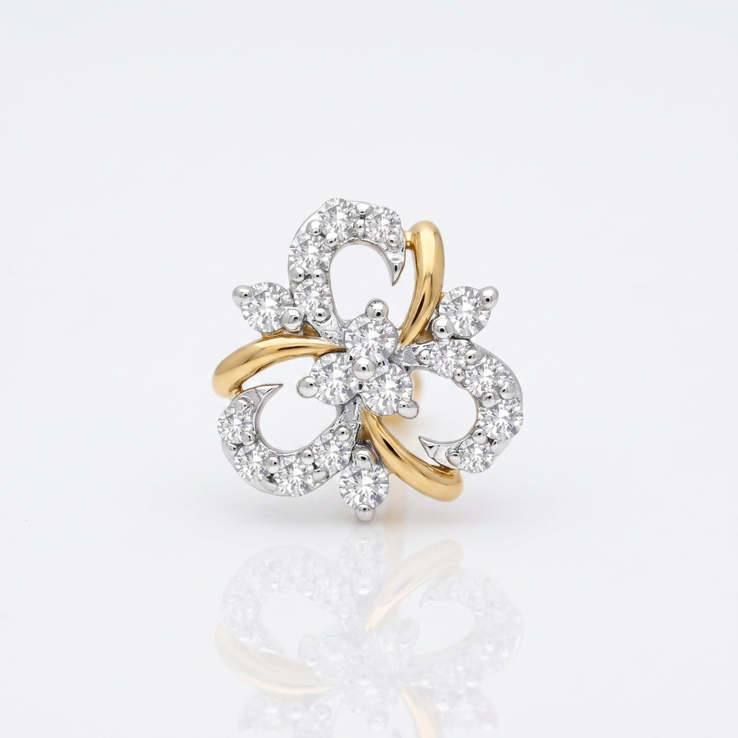 A two-tone yellow gold and white gold flower-shaped ring set with numerous clear round-cut diamonds, photographed on a clean white background with a soft reflection below.
