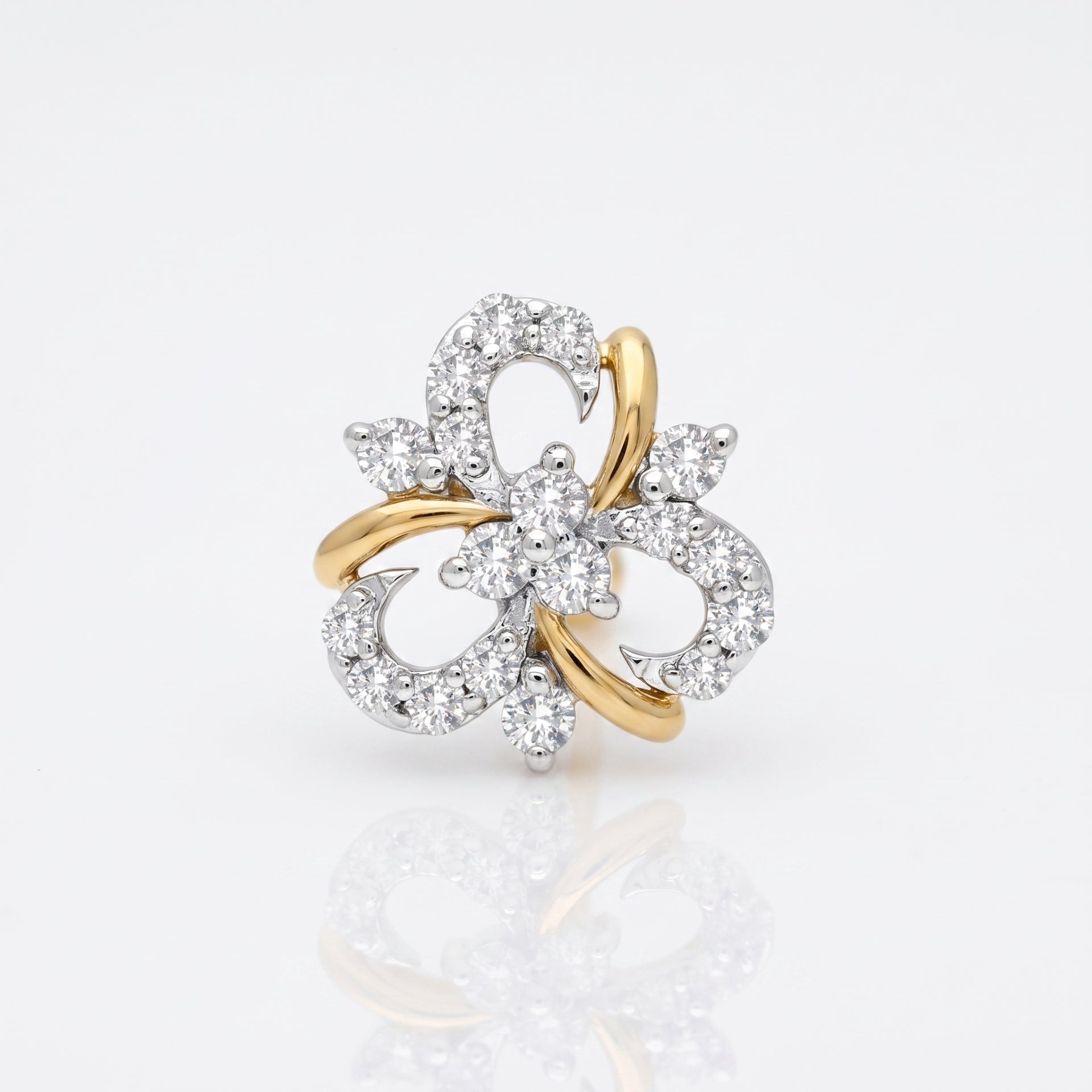 A two-tone yellow gold and white gold flower-shaped ring set with numerous clear round-cut diamonds, photographed on a clean white background with a soft reflection below.