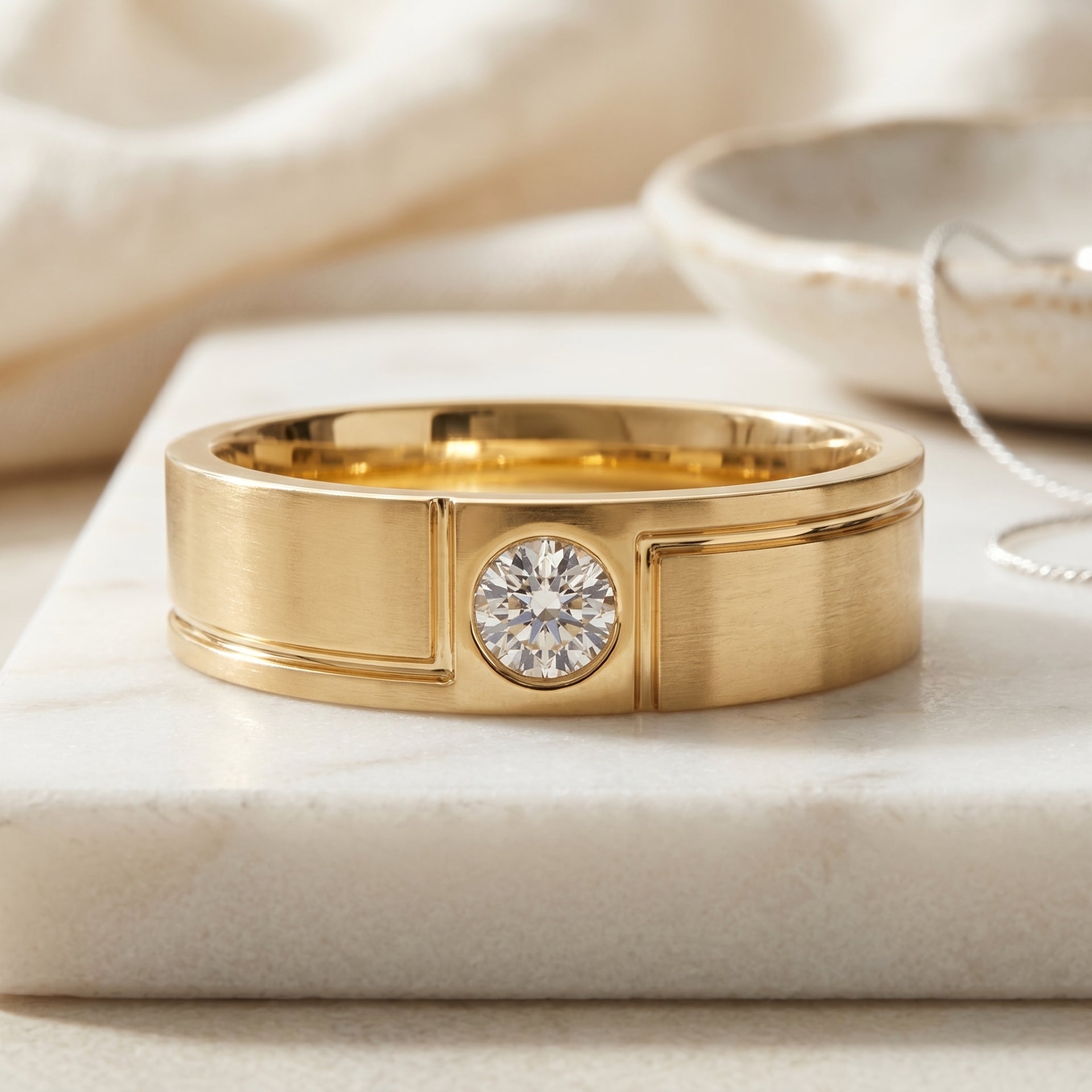 Gold ring with a diamond on a beige fabric background