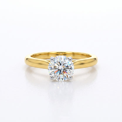 Gold ring with a diamond on a white background