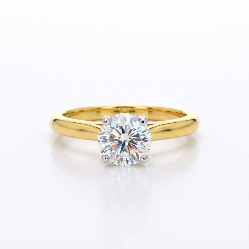 Gold ring with a diamond on a white background