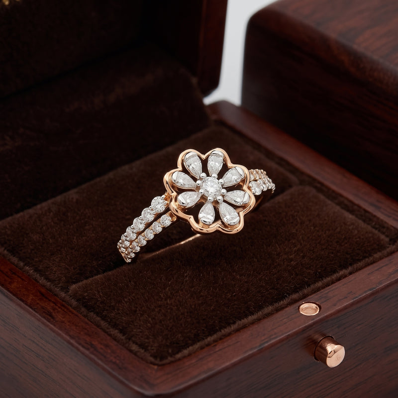 Rose gold ring with diamonds on a brown velvet cushion in a wooden box