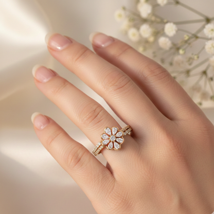 Hand wearing a floral diamond ring with a soft background