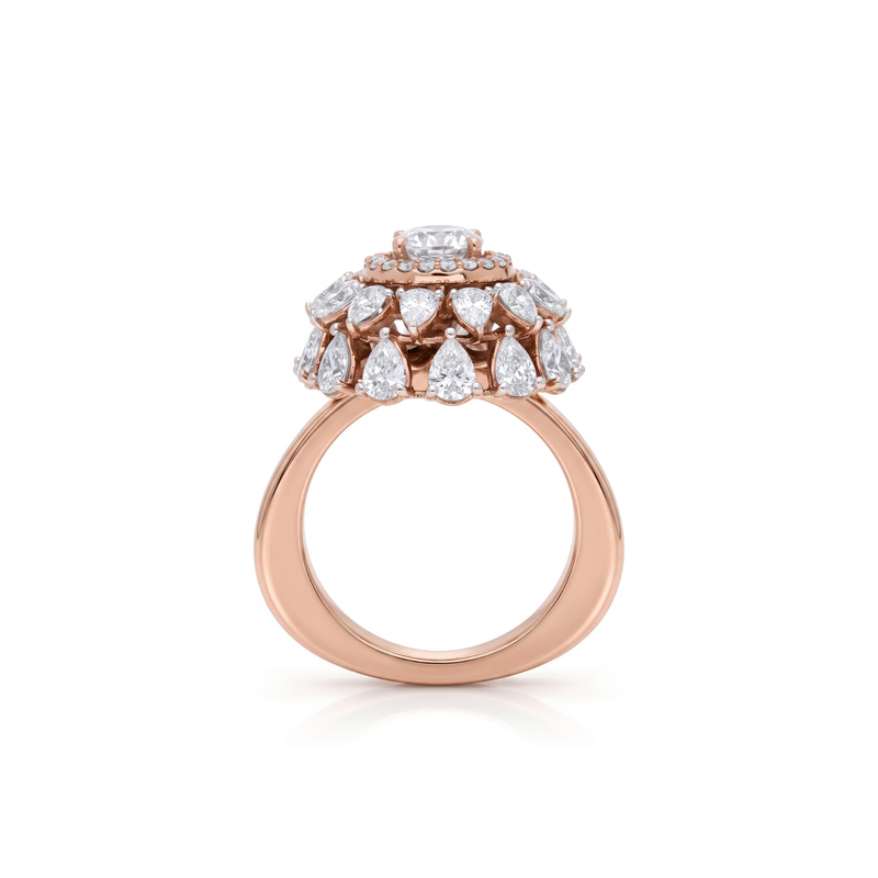 Rose gold ring with diamond teardrop design on a white background