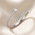 Silver ring with diamond accents on a beige background