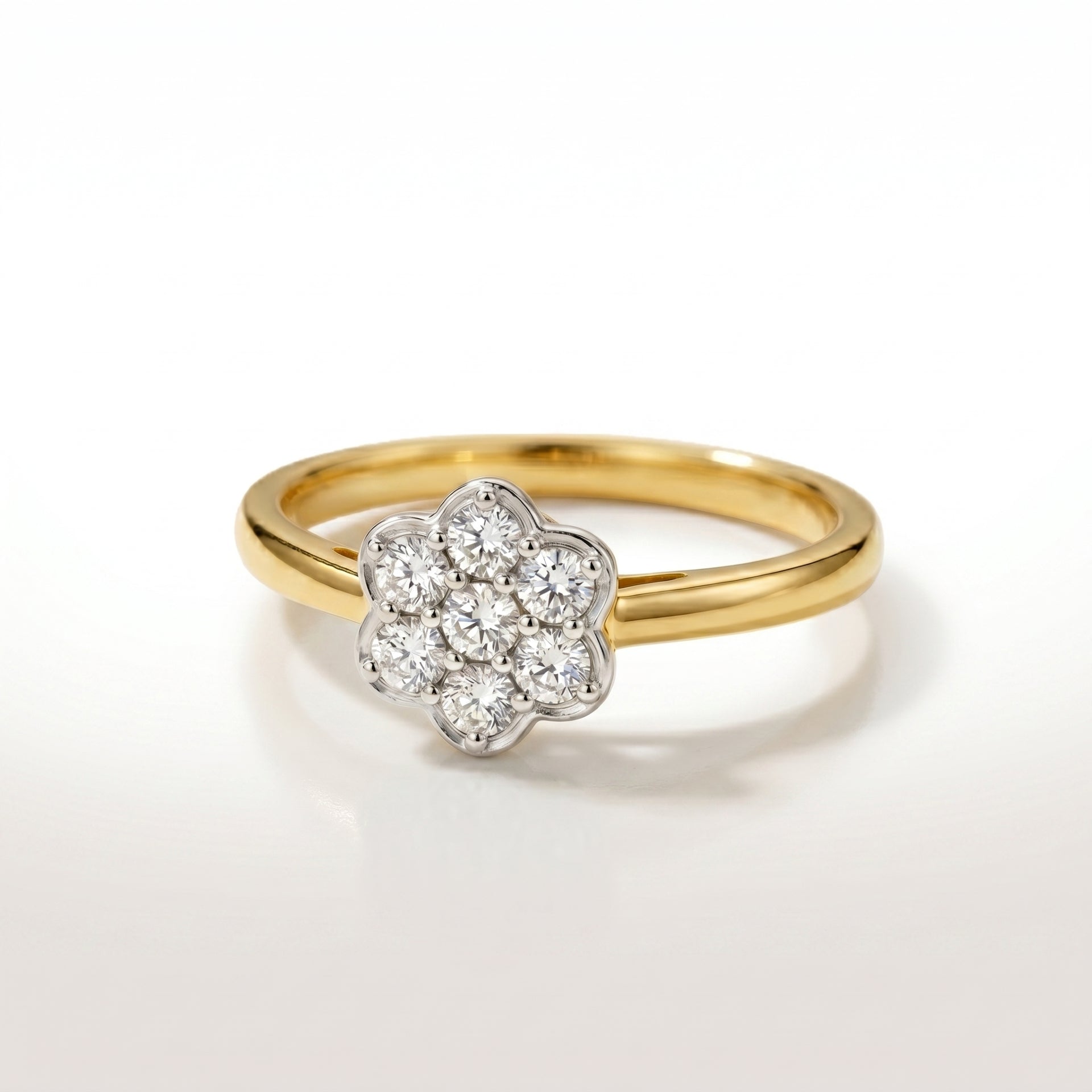 Gold ring with a diamond flower-shaped center on a white background