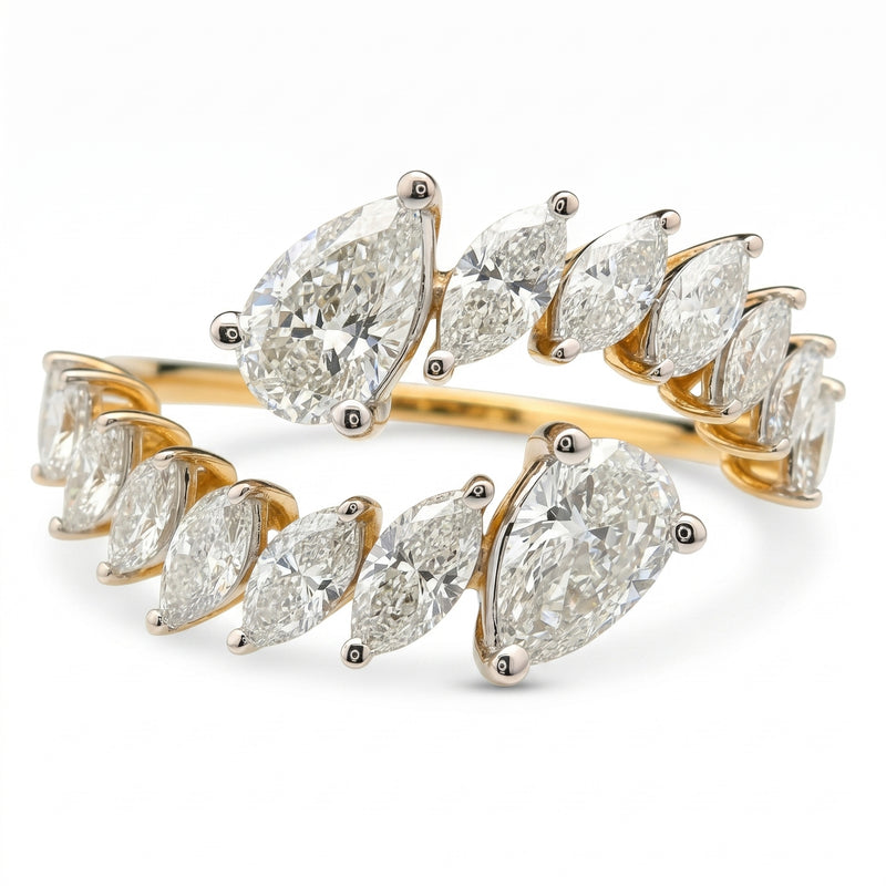 Open wrap-style gold ring featuring marquise and pear-shaped lab-grown diamonds with a white background