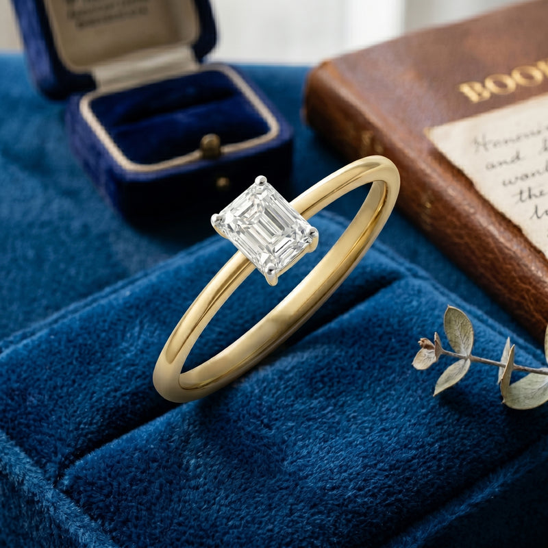 Gold ring with a diamond on a blue velvet surface