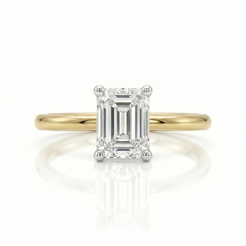 Gold ring with a diamond on a white background