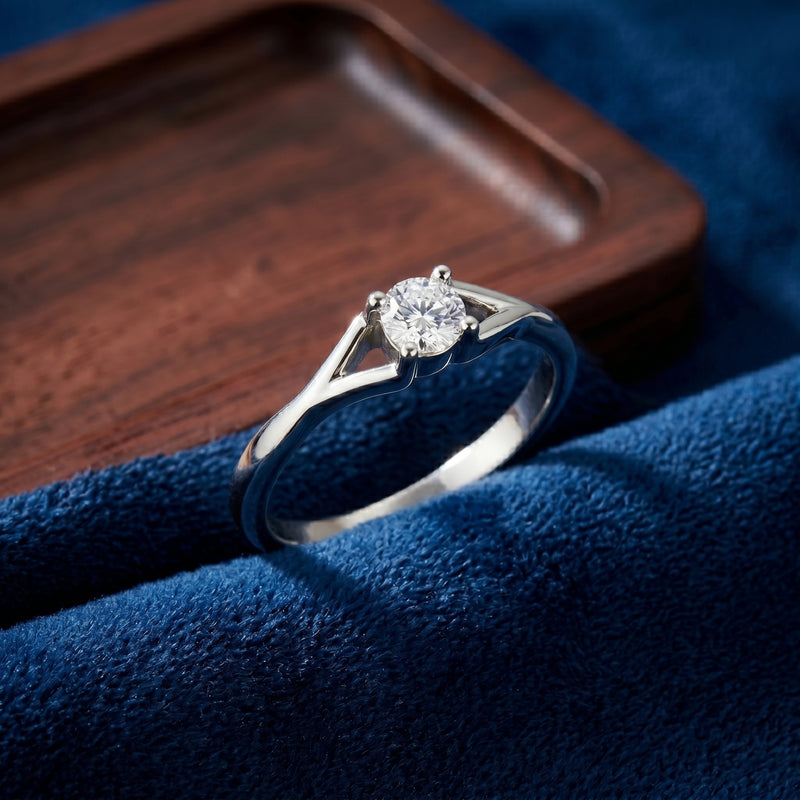 Solitaire lab-grown diamond ring displayed on a blue velvet jewelry surface.