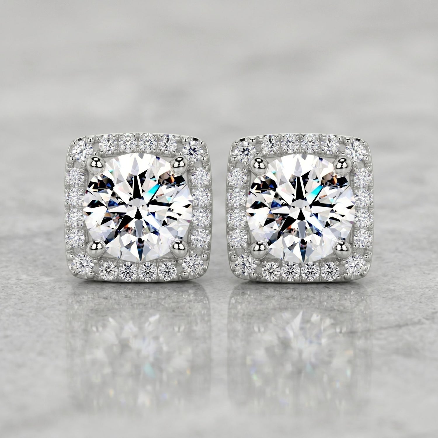 Square halo stud earrings featuring brilliant round lab-grown diamonds surrounded by a sparkling diamond halo on a polished marble surface.