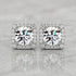 Square halo stud earrings featuring brilliant round lab-grown diamonds surrounded by a sparkling diamond halo on a polished marble surface.