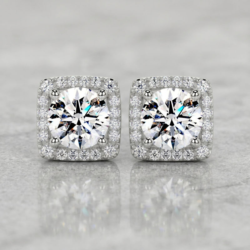 Square halo stud earrings featuring brilliant round lab-grown diamonds surrounded by a sparkling diamond halo on a polished marble surface.